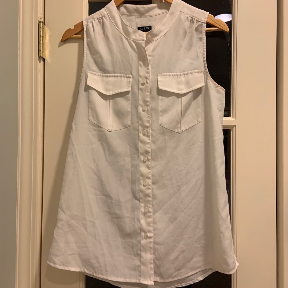 White sleeveless blouse with two front pockets